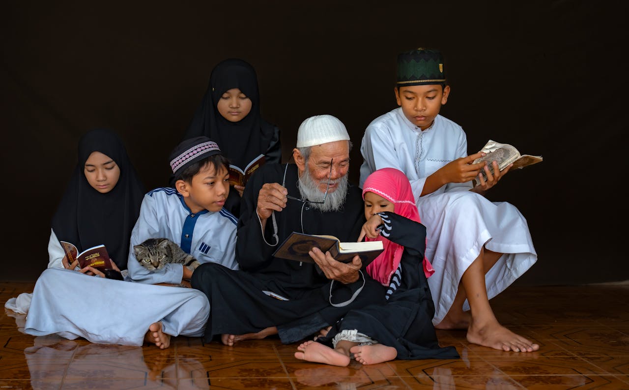 about-01 A multigenerational family reading books together, symbolizing cultural and spiritual connection.
